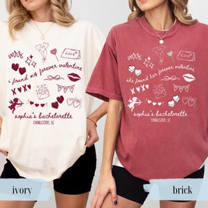 May include: Two t-shirts, one ivory and one brick-colored, feature a Valentine's Day theme. Each shirt has the text "Mrs." and "I found my forever valentine" or "She found her forever valentine". The shirts also include graphics and the text "Sophia's Bachelorette, Charleston, SC."