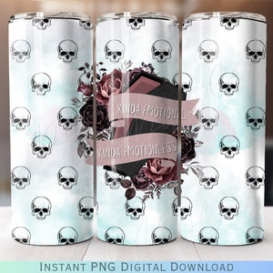 May include: A white tumbler with a blue and white watercolor background pattern. The tumbler is decorated with a floral design and a black and pink phone with the text "Kinda Emotional Kinda Emotionless". The tumbler is surrounded by white skulls.