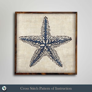 May include: A framed artwork featuring a blue starfish design on a beige textured background. The starfish is intricately detailed with a dark blue pattern. The frame is a dark brown color. The text at the bottom reads "Cross Stitch Pattern of Instruction."