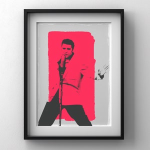 May include: A black and white image of a man singing into a microphone. He is wearing a white suit and has a pink background behind him.