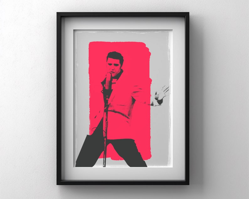 May include: A black and white image of a man singing into a microphone. He is wearing a white suit and has a pink background behind him.