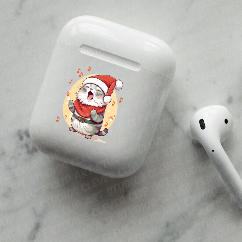 May include: White wireless charging case with a colorful sticker of a cat wearing a Santa hat and singing Christmas carols.