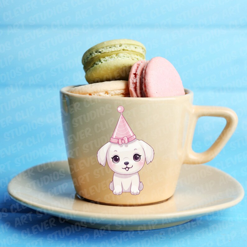 May include: A white teacup with a white dog wearing a pink party hat on it. The teacup is filled with macarons, two green and one pink.