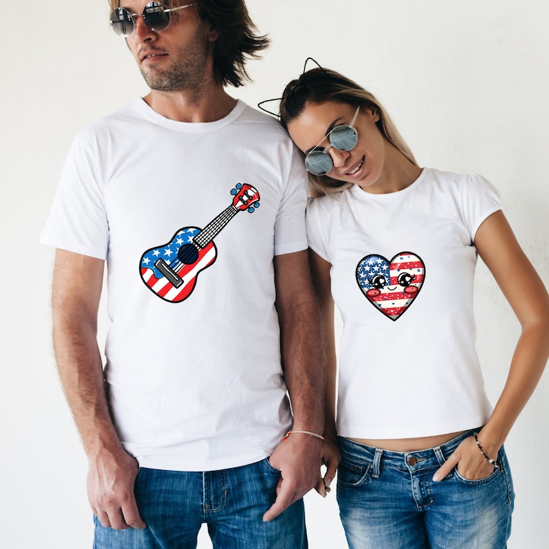 May include: A couple wearing white t-shirts with a patriotic theme. The man's shirt features a ukulele with an American flag design. The woman's shirt features a heart with an American flag design.
