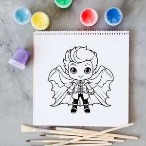 May include: A black and white line drawing of a cartoon vampire boy with wings on a white sheet of paper. There are paint pots and paint brushes on a gray surface.