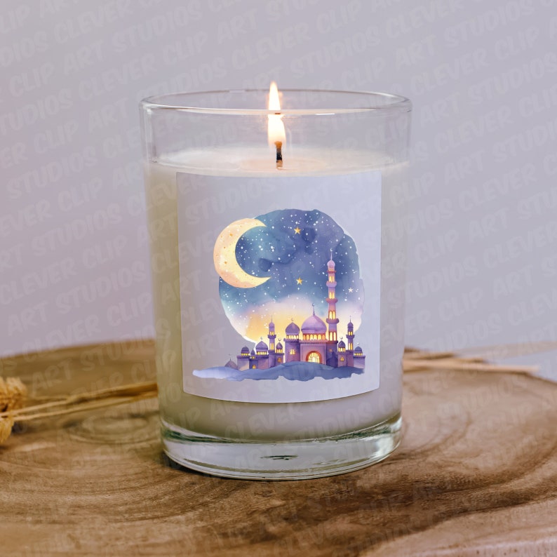 May include: A clear glass candle jar with a white candle inside. The candle has a label with a watercolor illustration of a mosque with a crescent moon and stars in the night sky.