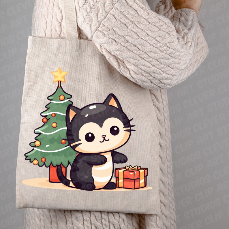 May include: A beige tote bag with a black cat holding a red gift box in front of a green Christmas tree with yellow ornaments and a yellow star on top.