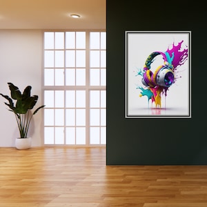 Puede incluir: Una impresión enmarcada de unos auriculares con salpicaduras de pintura de colores. Los auriculares son blancos con detalles en morado, amarillo y azul. Las salpicaduras de pintura son en tonos de rosa, azul y amarillo.