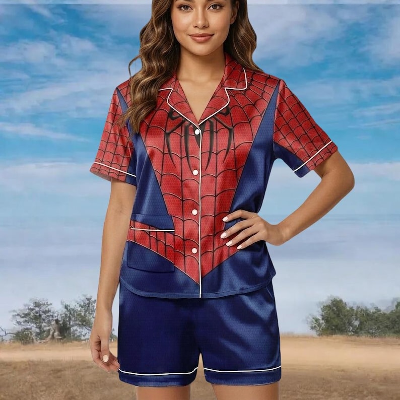 May include: A Spider-Man themed pajama set. The top is red and blue with a spiderweb pattern, white trim, and a button-up front. The shorts are solid blue with white trim. The set is made of a silky material. The pajamas are designed for comfort.