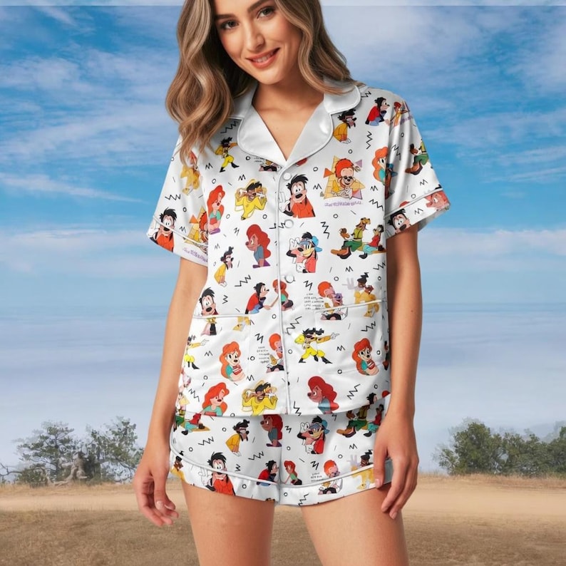 May include: A white ceramic mug with a black handle and the text "But First, Coffee" in a black, handwritten-style font. The mug is on a white surface.