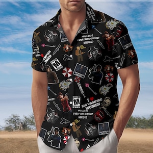 May include: Black short-sleeve button-down shirt with a repeating pattern of video game characters, weapons, and text. The shirt features the phrases "Where's Everyone Going? Bingo?" and "I Love Big Vampire Women."