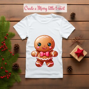 May include: White t-shirt with a gingerbread man design. The gingerbread man is brown with white icing and a pink bow tie. The text "Create a Merry little t-shirt" is at the top of the image.