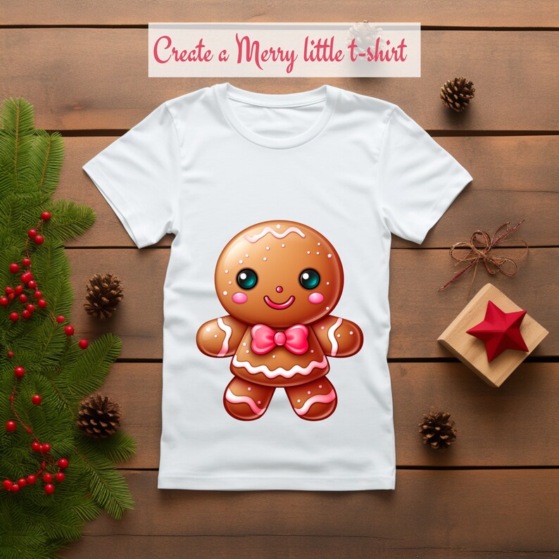 May include: White t-shirt with a gingerbread man design. The gingerbread man is brown with white icing and a pink bow tie. The text "Create a Merry little t-shirt" is at the top of the image.