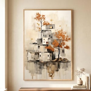 Könnte beinhalten: Abstrakter Kunstdruck mit einer Ansammlung geometrischer Gebäude in Grau- und Weißtönen, mit Bäumen mit orangefarbenen Blättern. Das Kunstwerk ist in hellem Holz gerahmt und spiegelt sich in einem Gewässer wider. Die Farbpalette ist neutral mit Farbtupfern in Orange.