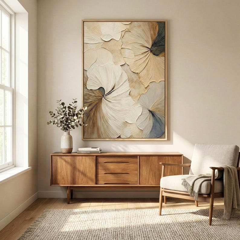 Minimalist entryway interior featuring framed 3D floral wall art in beige and white tones above a wooden sideboard, styled with neutral decor and soft natural light.