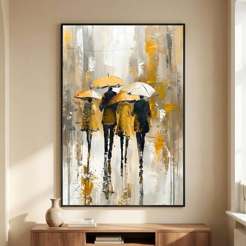 Modern umbrella wall art featuring abstract figures walking in the rain with yellow umbrellas, displayed above a wooden console table in a neutral contemporary living room.
