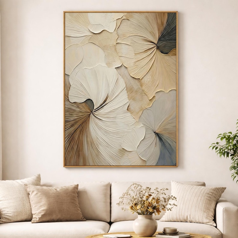 Neutral living room with textured 3D floral wall art in soft beige and white colors, displayed above a cream sofa for a modern minimalist home decor look.