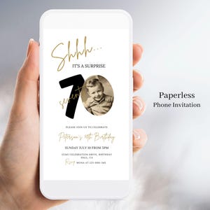 May include: A black and gold phone screen displaying a birthday invitation. The invitation features a large black number 70 with gold text that says "Shhh... It's a surprise". The invitation also includes a photo of a young boy and details for the birthday party.