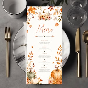 May include: A vertical rectangular menu card featuring a white background with watercolor illustrations of orange and brown autumn leaves, flowers, and pumpkins. The text reads Menu, Appetizers, Salads, Entrees, Sides, and Desserts in orange font.