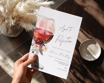 May include: A white invitation card with a watercolor illustration of a glass of red wine. The text on the card reads "Aged to Perfection" and includes details for a birthday party.