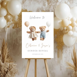 May include: A gender reveal sign on a wooden easel. The sign reads "Welcome to Catherine & Jason's Gender Reveal" with the date September 14th, 2025. Two teddy bears hold balloons. The background includes balloons and decorative elements.