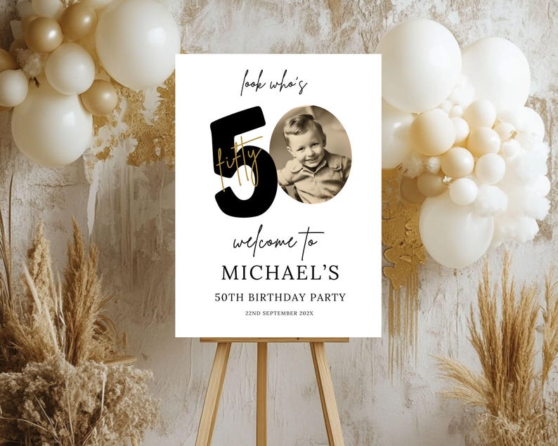 May include: A white welcome sign with black text and a gold accent. The sign says "Look who's 50 fifty" with a photo of a young boy. The sign also says "Welcome to Michael's 50th Birthday Party 22nd September 202X".