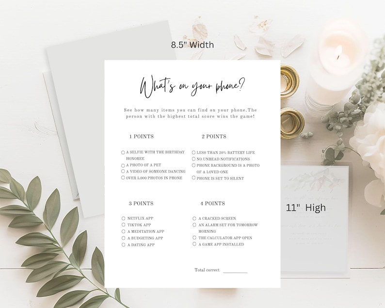 May include: A white paper game sheet with the text "What's on your phone?" and a list of items to find on your phone. The sheet is 8.5 inches wide and 11 inches high. The game is designed to see who can find the most items.