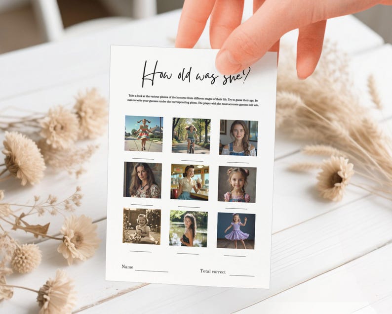May include: A white card with the text "How old was she?" in black script. The card features nine photos of women at different ages, with spaces for names and total correct answers. The card is held by a hand.