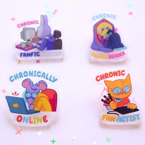 May include: Four clear acrylic pins with cartoon characters. One pin features a purple rabbit at a computer, labeled "Fanfic Writer." Another shows a figure in a purple hood, labeled "Fanfic Reader." A mouse is "Chronically Online," and an orange cat is a "Fan Artist."