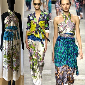 May include: Three models are wearing different styles of patterned silk tops and trousers. The tops are all halter style and tied at the waist. The trousers are wide-legged and have a floral print. The models are all wearing sunglasses and have their hair pulled back.