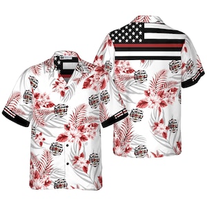 May include: White Hawaiian shirt featuring a floral and leaf pattern in red and gray. The shirt has a firefighter emblem and an American flag design on the back. The sleeves have black trim with white text.
