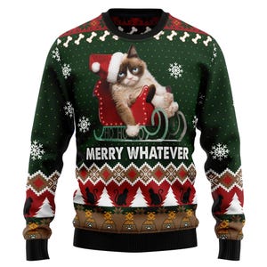 May include: A green Christmas sweater featuring a grumpy cat in a Santa hat riding a red sleigh. The sweater has a pattern of snowflakes, bones, and cats, with the text "MERRY WHATEVER" across the front. The cuffs and collar are black.