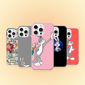 May include: Five smartphone cases featuring Bugs Bunny graphics. One case has a checkered pattern with text, one is gray with a reclining character, one is pink with a waving character holding a carrot, one is black with a circular portrait, and one is red.
