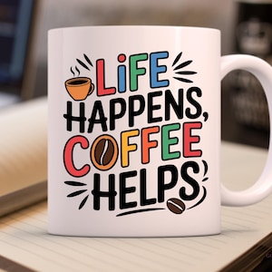 May include: White ceramic coffee mug with a colorful graphic that reads "Life Happens, Coffee Helps". The mug has a black handle and a black coffee cup graphic with steam coming from it.