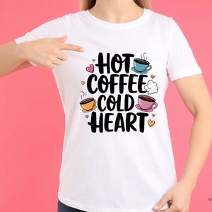 May include: White t-shirt with a graphic design that says "Hot Coffee Cold Heart" with illustrations of coffee cups and hearts.