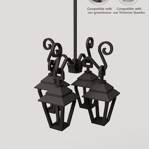 May include: Black metal chandelier with four lantern-style lights. The fixture has decorative scrollwork and is designed to be compatible with a greenhouse or Victorian gazebo. The image includes text that says "Compatible with our greenhouse" and "Compatible with our Victorian Gazebo."