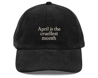 Puede incluir: Gorra de béisbol negra de pana con la frase bordada "April is the cruellest month" en blanco. La gorra tiene una visera curva y una corona redonda, ideal para uso diario y actividades informales.