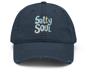 May include: A navy blue distressed baseball cap with the text "Salty Soul" embroidered in white, blue, and orange.