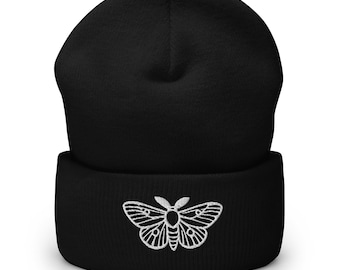 May include: Black beanie with a white embroidered moth design.