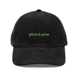 May include: A black corduroy baseball cap with green embroidered text that reads "glitch & grow".