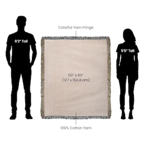 May include: A beige woven throw blanket with a colorful yarn fringe. The blanket is 50" x 60" and made of 100% cotton yarn. The image includes the silhouettes of a 6'2" tall person and a 5'5" tall person.