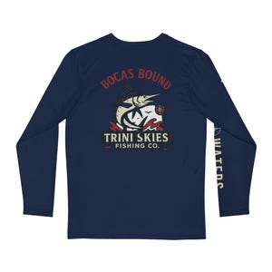May include: Navy blue long-sleeve shirt with a marlin fish graphic and the text "Bocas Bound Trini Skies Fishing Co."