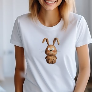 May include: White t-shirt with a brown cartoon bunny rabbit graphic.