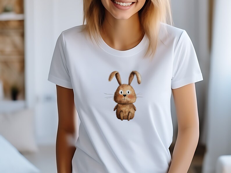 May include: White t-shirt with a brown cartoon bunny rabbit graphic.