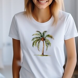 May include: White t-shirt with a watercolor illustration of a palm tree with a brown coconut.