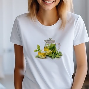 May include: White t-shirt with a graphic of a glass teapot and a glass of green tea with lemon and mint leaves.