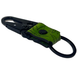 May include: Black metal key chain with a green leather strap featuring a marijuana leaf design.