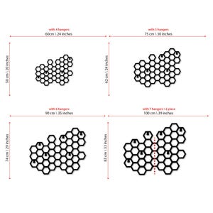 May include: Diagram showing four different sizes of honeycomb wall organizers with 4, 5, 6, and 7 hangers. The organizers are made of black metal and have a honeycomb pattern. The dimensions of each organizer are listed in inches and centimeters.