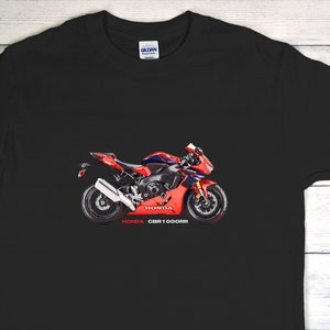 May include: Black t-shirt with a red and white Honda CBR1000RR motorcycle graphic.