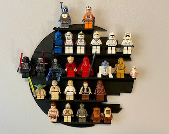 May include: A black Star Wars themed display shelf with various Star Wars Lego minifigures, including Darth Vader, Yoda, and Stormtroopers.